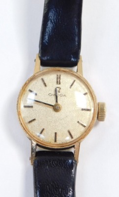 An Omega 9ct gold cased lady's wristwatch, circular champagne dials with gold batons, on a leather strap. - 4