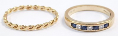 An 18ct gold lady's wedding band, size Q, 1.5g, together with a 9ct gold sapphire and diamond seven stone half hoop eternity ring, in a rub over setting, size L, 1.9g all in.