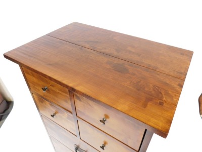 An Eastern hardwood narrow chest of drawers, for Laura Ashley, with a plank top above an arrangement of four short and four long drawers, with metal handles, on a plinth, 146cm high, 67cm wide, 47cm deep. - 2