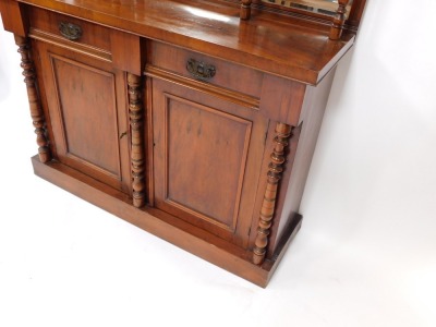 A Victorian walnut chiffonier, or side cabinet, the raised back with three bevelled mirrored plates, on turned supports, the base with two frieze drawers above to panelled doors, flanked by turned pillars on a plinth, 192cm high, 119cm wide. - 4