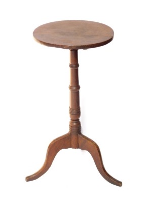A 19thC oak wine table, the circular top on a turned column and tripod base, the top 36cm diameter.