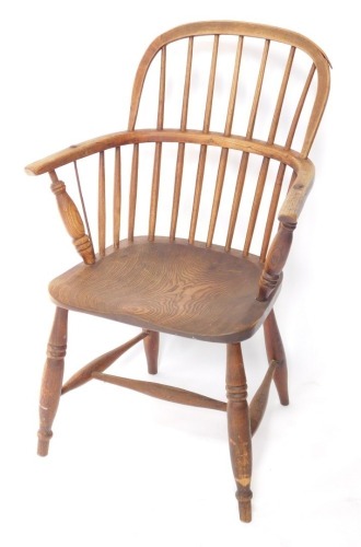 A 19thC ash and elm Windsor chair, the shaped back and arms with spindle turned supports, with solid seat on turned legs with H stretcher. (AF)