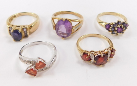 A collection of five 9ct gold dress rings, with multiple semi precious stones.