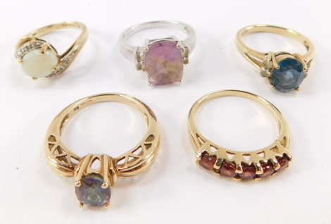 A collection of five 9ct gold dress rings, with multiple semi precious stones.