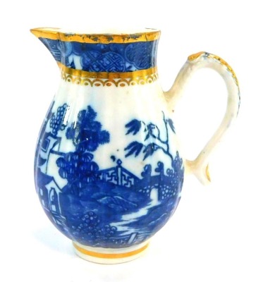 A Caughley late 18thC porcelain cream jug, having gilt and blue printed rim with sparrow beak spout, above a fluted main section, with temple pattern decoration, with moulded and gilt handle, mark to base, c1780, 11cm high.