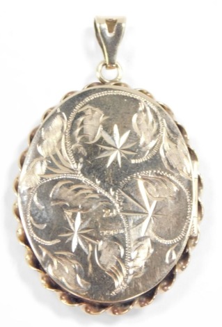 A 9ct gold oval photo locket, foliate engraved, within a ropetwist border, 9.8g.