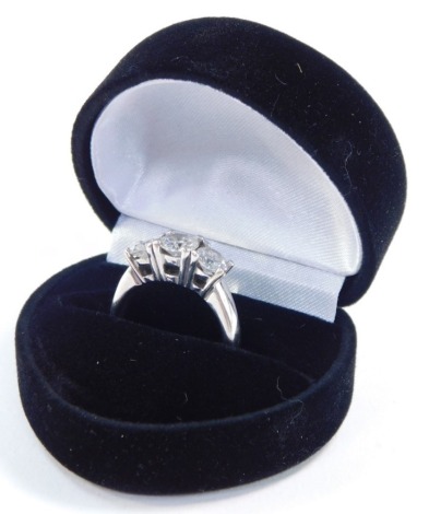 A diamond three stone ring, claw set in white metal, stamped 14k, approximately 1.75cts, size N, 5.0g.