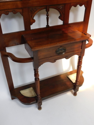 A Victorian walnut hall stand, with a central cartouche shaped mirror, with bevelled plate, surrounded by foliate carved panels, cast hooks, etc., the base with a frieze drawer, flanked by recesses for umbrellas, each with a metal liner, 106cm wide. - 3