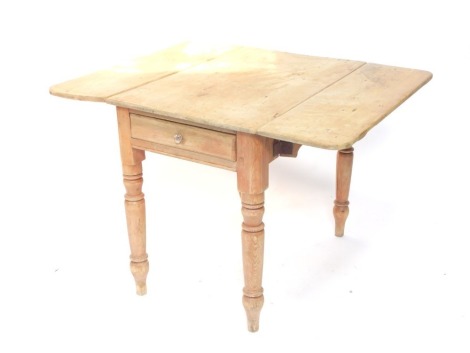 A Victorian stripped pine Pembroke table, the top with rounded corners, above a frieze drawer, on turned tapering legs, 72cm high, the top 107cm x 90cm.