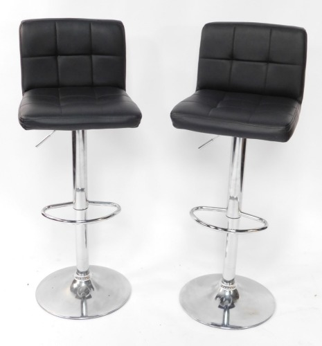 A pair of black leatherette and chrome plated adjustable breakfast bar stools.