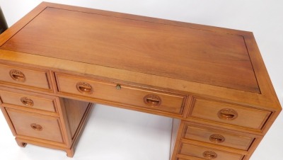 An Oriental hardwood desk, with a paneled top above an arrangement of nine drawers, each with recessed carved handles, on bracket feet, 79cm high, 137cm wide. - 2