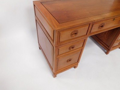 An Oriental hardwood desk, with a paneled top above an arrangement of nine drawers, each with recessed carved handles, on bracket feet, 79cm high, 137cm wide. - 3