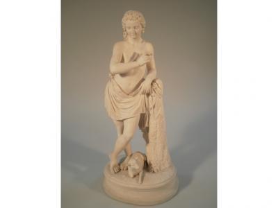 A Victorian Parian figure of Apollo in standing pose resting on a tree