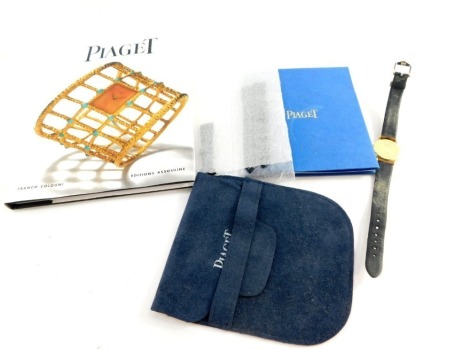 A Piaget Mecanique 18ct gold cased wristwatch, circular white dial bearing Roman numerals, number to back plate 90005/829751, on a leather strap, with bag, International guarantee certificate and a book on Piaget by Franko Cologni.