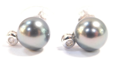 A pair of Tahitian black cultured pearl and diamond earrings, set in white metal stamped 14K, pearls approximately 8mm diameter.