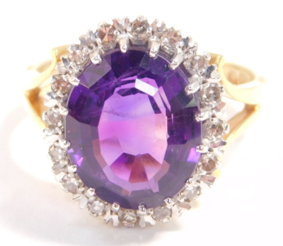 A 18ct gold and amethyst ring, oval cut in a surround of diamonds, amethyst approximately 5ct, size K/L, 6.5g. - 2