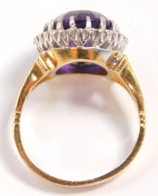 A 18ct gold and amethyst ring, oval cut in a surround of diamonds, amethyst approximately 5ct, size K/L, 6.5g. - 5