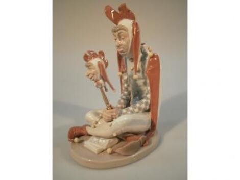 A Lladro Norman Rockwell figure of a seated jester