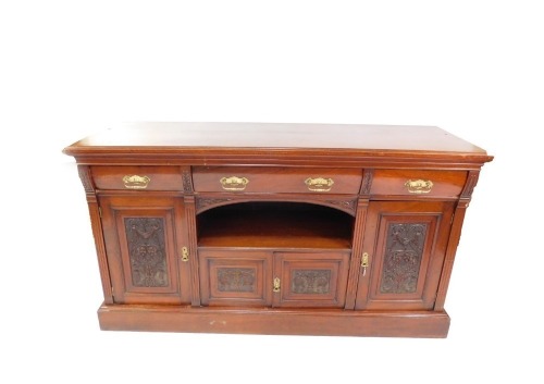 A Victorian mahogany sideboard, with three cushion drawers, over a central recess, above a pair of carved panelled doors, flanked by two further doors, each enclosing shelves, one with a sliding bottle tray, raised on a plinth base, 101cm high, 181.5cm wi