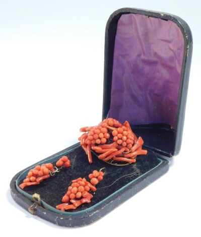 A Victorian coral brooch and matching earrings, of grape and vine form, boxed.