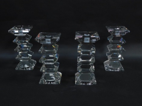 A set of four cut glass candlesticks, of five sectional form, 22.5cm high. (AF)