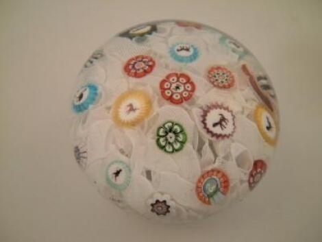 A 19thC scrambled paperweight with millefiori and animal canes with twisted opaque ribbons