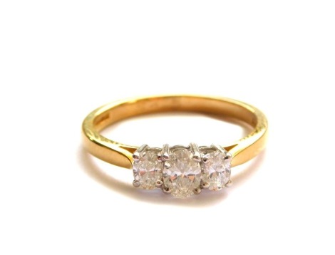 An 18ct gold and diamond three stone ring, set with oval cut diamonds, approx 0.4cts, size M, 2.9g.