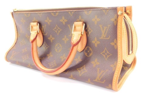 A Louis Vuitton monogram canvas Popincourt handbag, with tan leather trim and handle, with a central zipped compartment with single pocket, stamped to interior Louis Vuitton Paris made in France, with dustbag, 12cm high, 30cm wide, 12cm deep.