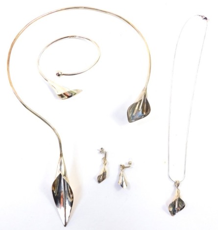 A silver lily jewellery set, comprising a bangle, torc necklace, drop necklace and a pair of earrings, with makers stamp, KFD Jewellery Designer, each piece hall marked silver, the bracelet 7cm diameter, the torc necklace 15cm wide, approx 50g. (boxed)