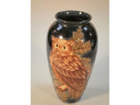 A Moorcroft ovoid vase decorated with an eagle owl amid oak leaves