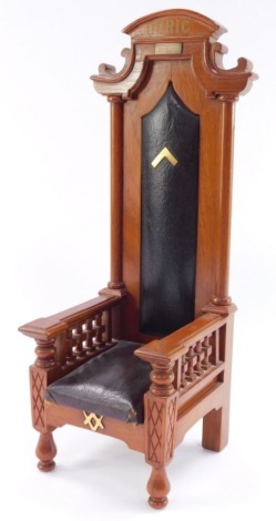 A Masonic light oak model of a Doric highchair, with leatherette seat and back, plaque named to H J Kelly P.D.G.W., WM1912, 1914, 1922, 1922 and 1947, 40cm high.