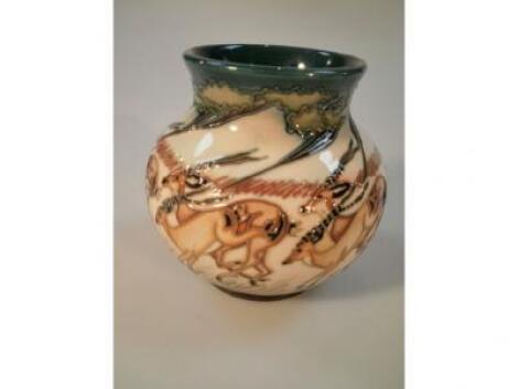 A Moorcroft squat ovoid vase decorated with running impala