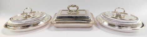 Three electro plated entree dishes, being a pair of oval examples with semi fluted covers, and a rectangular example by Thomas of Bond Street, with gadrooned borders.