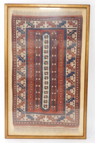 A Persian type rug, with a geometric striped design in blue, cream and burnt orange, with one wide and one narrow border, fringed ends, framed, 133cm x 84cm.