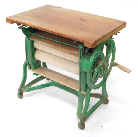 A Ewbank green painted cast iron mangle, with pine top, 76cm wide.