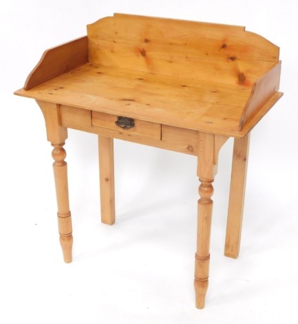 A pine washstand, with a raised back, frieze drawer, on turned tapering legs, 81.5cm wide.