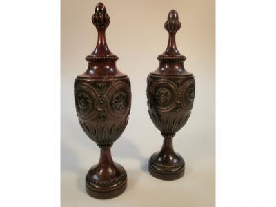 A pair of 19thC carved walnut urns with fixed covers