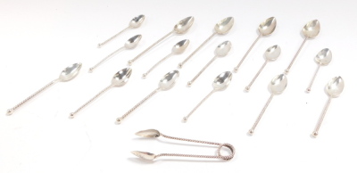 A set of twelve Dutch early 20thC silver coffee spoons, with spiral twist handles, together with a pair of sugar tongs, and four tea spoons, 5.27oz.