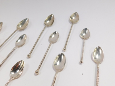 A set of twelve Dutch early 20thC silver coffee spoons, with spiral twist handles, together with a pair of sugar tongs, and four tea spoons, 5.27oz. - 2