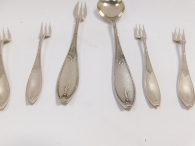 A pair of silver napkin rings, with engine turned decoration, Birmingham 1957, further napkin ring, monogram engraved, Birmingham 1901 (AF), three coffee spoons with coiled handles, salt spoon, Sheffield 1933, 2.54oz, and a Victorian silver plated trowel - 2