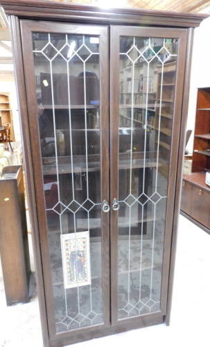 An oak finished glazed bookcase, with cornice top above two glass doors, 187cm high, 93cm wide, 36cm deep.