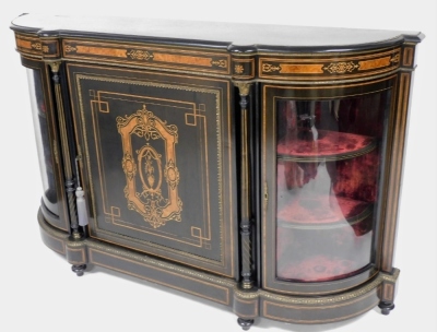 A Victorian ebonised credenza, with gilt metal mounts, the panelled door inlaid in burr walnut with an urn surmounted by a rectangular cartouche flanked by two turned pillars and bowed glazed doors, enclosing a velvet lined interior, on bun feet, 114cm hi