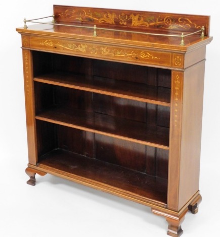 An Edwardian walnut open bookcase, with marquetry inlay of dragons, scrolls and flowers, with a top brass gallery, above three shelves on ogee bracket feet, 113cm high, 106cm wide, 33cm deep.