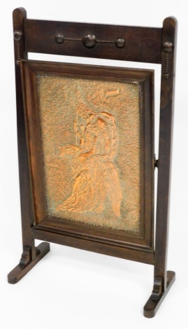 An early 20thC oak framed brass fire screen, the copper panel Brunhild Siegfried from German legend, 85cm high, 50cm wide, 25cm deep.