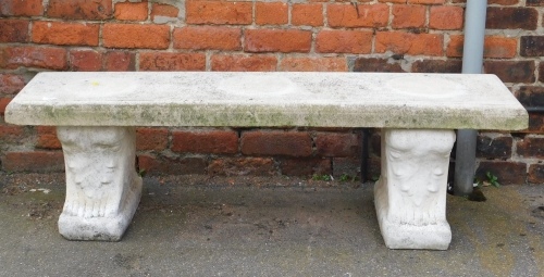 A reconstituted stone garden bench, the rectangular top on two plinths, 41cm high, 140cm wide, 37cm deep.