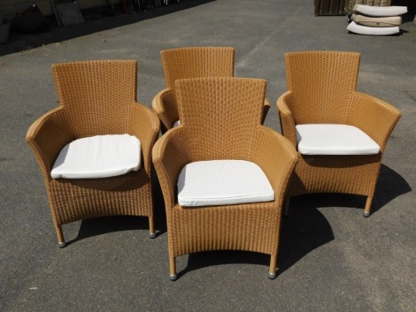 A set of four bramble crest garden furniture rush seated chairs, each with a brown plastic finish on a metal frame, 82cm high, 48cm wide, 47cm deep. Provenance: Purchased in 2009 from Bramblecrest for £213 per chair.