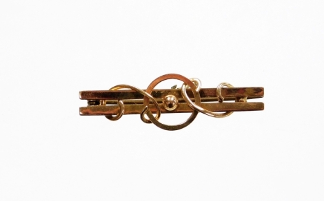 A bar brooch, of two bar design with twist and circular ball decoration, yellow metal, unmarked, on single pin back with safety chain, 4cm long, 2.5g all in. (AF)