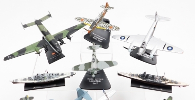 A group of diecast model aircrafts, to include mainly examples on stands, to include Burma Bridge Busters, Russia Front Kursk, Nazi German 1944 Junkers Jew, War In The Pacific, Vought F4U Corsair, Battle of Britain 1940, Messerschmitt Bf 109 E-4, Defence - 2