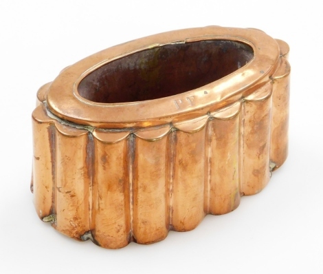 A Victorian copper jelly mould, of oval design with turreted borders stamped PF to upper rim, 9cm high, 17cm wide.