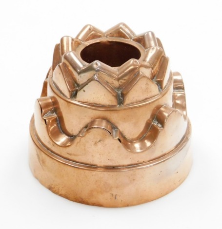 A Victorian copper jelly mould, with castle top and fluted borders, bearing the stamp M to the base, 12cm high, 15cm wide.